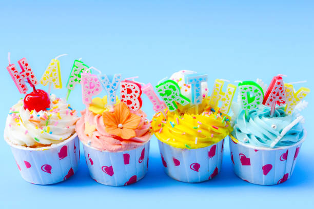istock Birthday cupcake with candles on color background 866218070