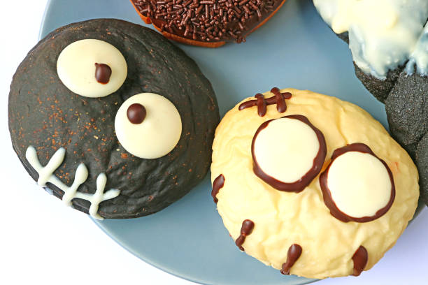 istock Closed up Black and White Monsters Shaped Doughnuts Served on the Plate for Halloween 866218574