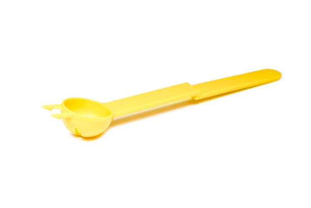 istock Close up unusual yellow plastic spoon isolated 866219160