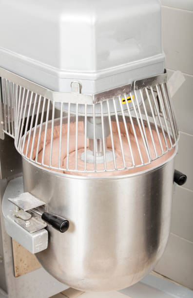 chef is preparing cake mix in industrial bread mixer- kneading machine