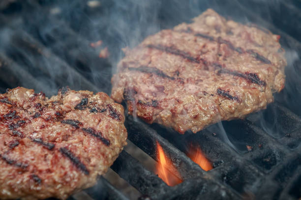 istock Succulent and appetizing beef hamburgers are roasting on grill grid 866222080