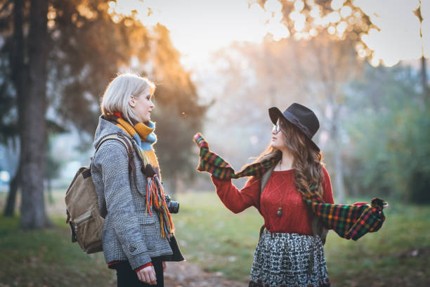 istock Two tourist women walk through park 866239066