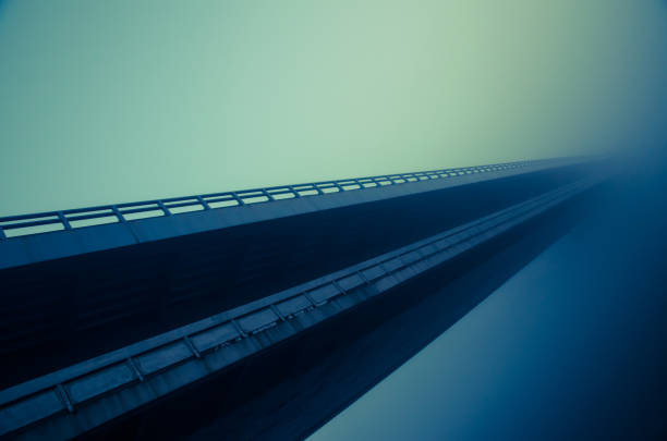 istock bridge in autumn fog 866244628