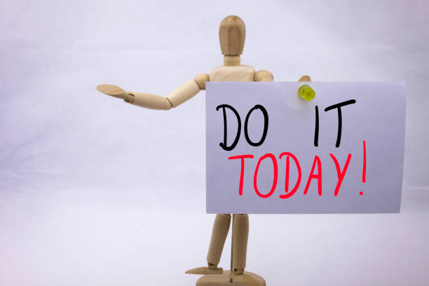 istock A Conceptual yellow Hand writing caption inscription written sticky note with word Do It TODAY With black ink on a sticky note pinned to a hand of a sculpture 866247766