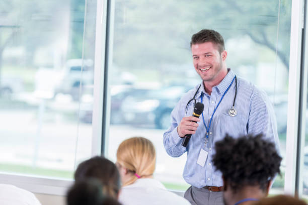 istock Cheerful doctor talks with group of colleagues 866255326