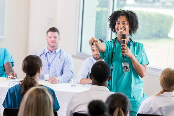 istock Healthcare seminar speaker calls on someone to ask question 866255356