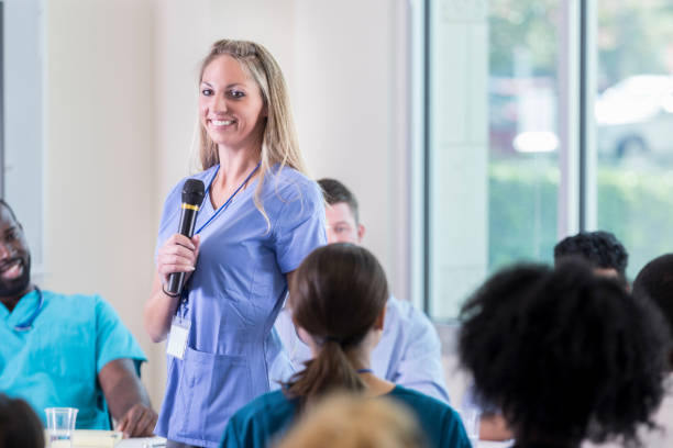 istock Confident female nurse asks question during nursing seminar 866255360