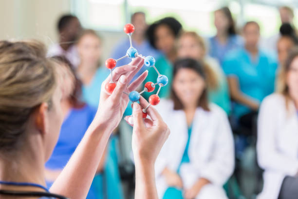 istock Doctor uses molecular structure model during lecture at medical conference 866255378