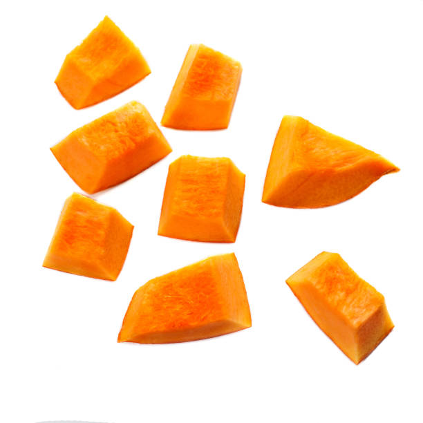 Pumpkin pieces cut in a  cube slice isolated on white background. Diced Pumpkin, close up. Pumpkin pieces cut in a  cube slice isolated on white background. Diced Pumpkin, close up. carving food photos stock pictures, royalty-free photos & images