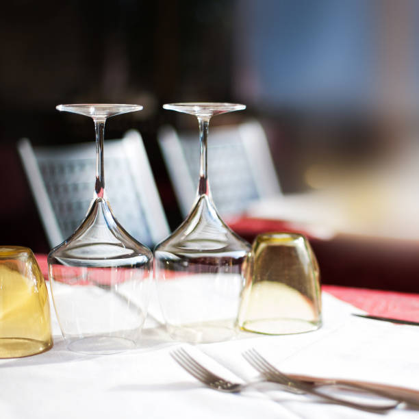 istock Empty glasses set in restaurant with wine glasses and plates for food. Served for a dinner table setting close up 866261084