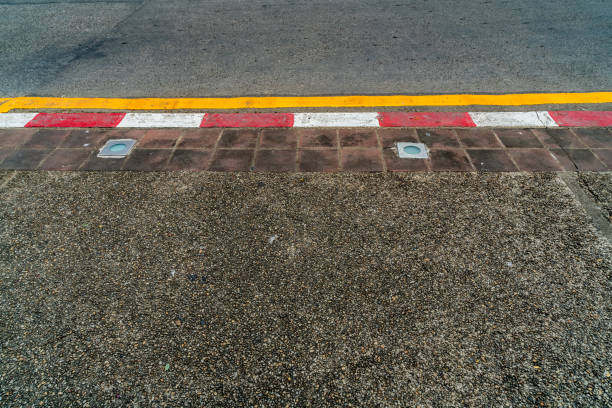 istock Red and white concrete road curb 866261174