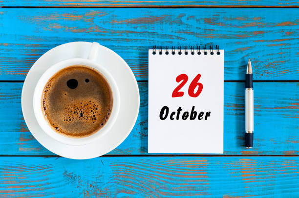 istock October 26th. Day 26 of october month, calendar on workbook with coffee cup at student workplace background. Autumn time 866268126