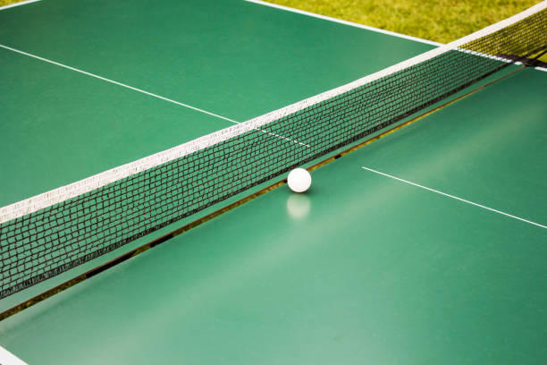 istock Table tennis, ping-pong table and the white ball on a green table. 866275540