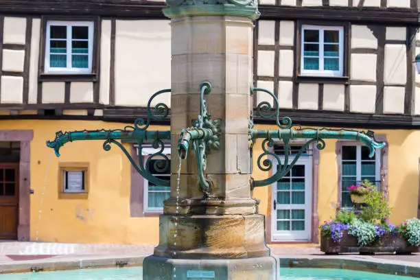 The Schwendi fountain with the bronze statue of Bartholdi in the square of the former customs office in the old French town of Colmar in Alsace.