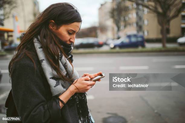 Young Woman Walking In Berlin Checking Her Mobile Phone Stock Photo - Download Image Now