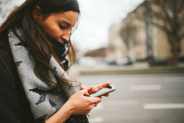 istock Young woman walking in Berlin, checking her mobile phone 866280412