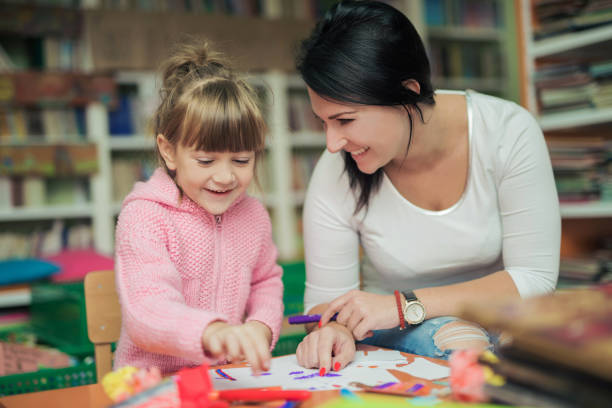 Mom and doughter drawing together in a library