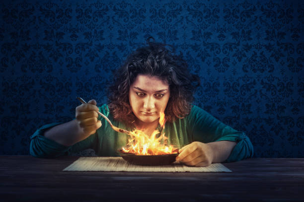 Young woman eating spicy food. stock photo