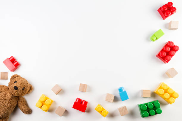 kids toys background with teddy bear and colorful blocks - brinquedo imagens e fotografias de stock