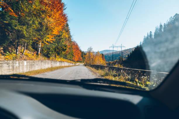 istock woman driving car in carpathian mountains 866298876