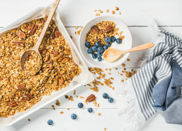 istock Oat granola with pecan nuts, yogurt and blueberry in bowl 866302080