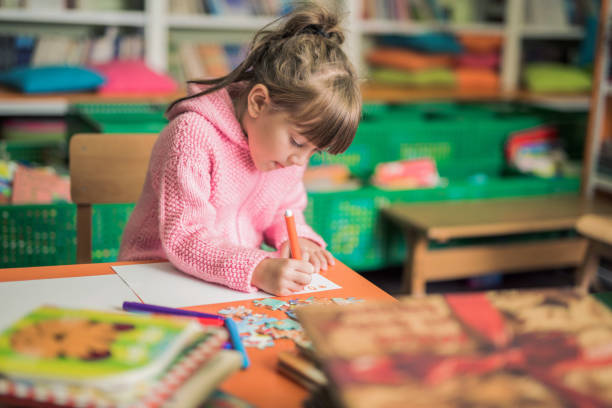 istock Young girl drawing in library 866302508