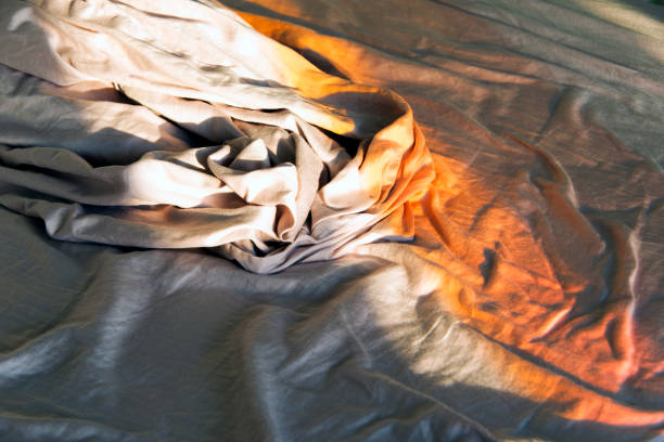 istock Sun light on the sheets of a bed 866309450