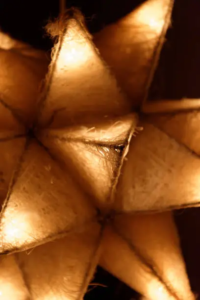 A glowing Christmas star decoration in close up