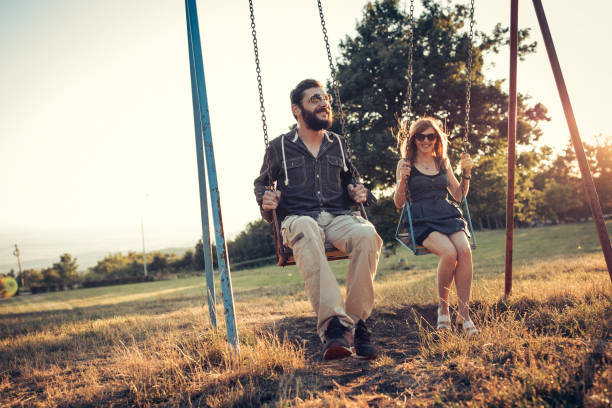 istock Young couple swinging 866317884