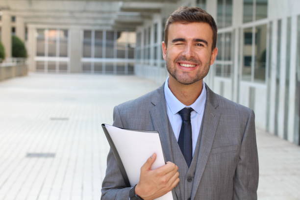 istock Cute businessman winking close up 866325450
