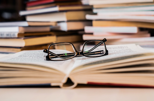 Reading glasses on a book. Close-up