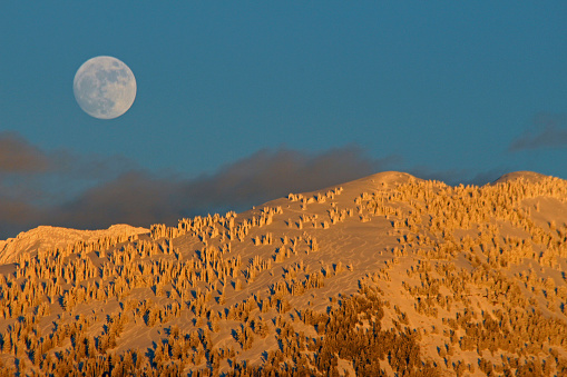 A mid-winter moon rises over the Grand Teton foothills near Driggs, Idaho.