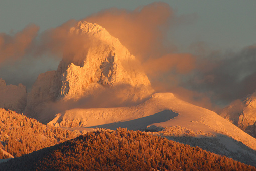 The evening rays of the sun ride the crisp mountain air over the Grand Tetons Mountains in Grand Teton National Park, Wyoming.This photo is taken from the west side of the moutains near Driggs, Idaho.