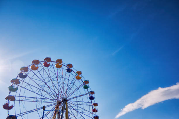 istock Ferris wheel on the background of blue sky 866340840