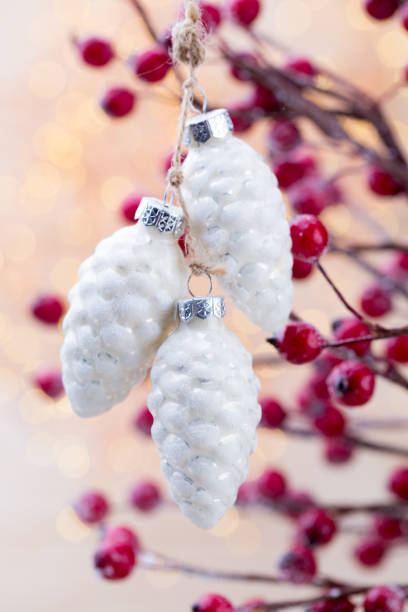 istock Christmas cone with red berries on a bokeh background. 866350562