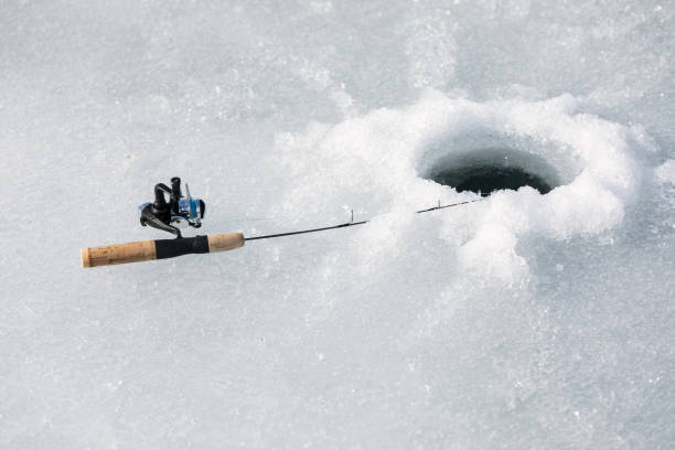 istock Ice Fishing Rod Laying Down on Hole 866354394