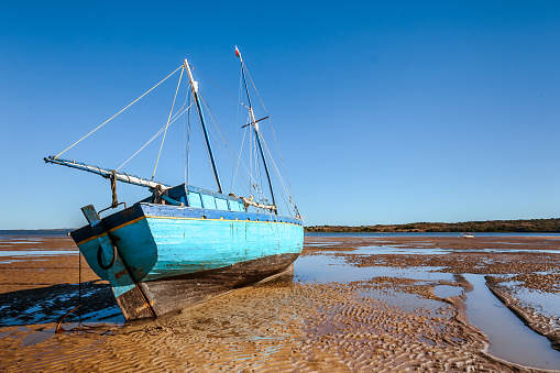 Malagasy schooner beached at low tide on the Analalava beach, west of Madagascar