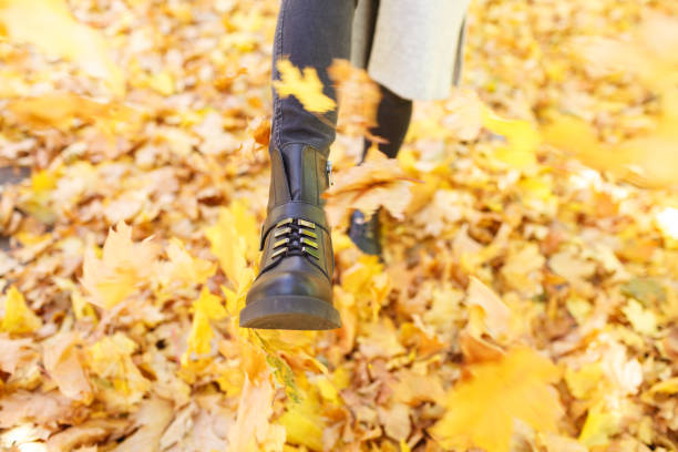 istock Girl in a white coat on an autumn background 866364870