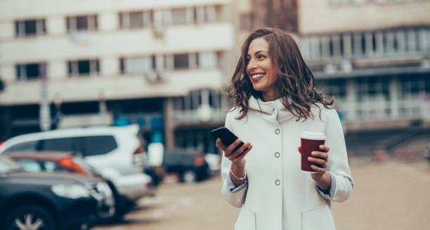 istock Woman texting and drinking coffee in the city 866371632