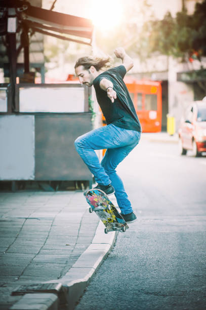 istock Pro skater doing tricks and jumps on street. Free ride 866374734
