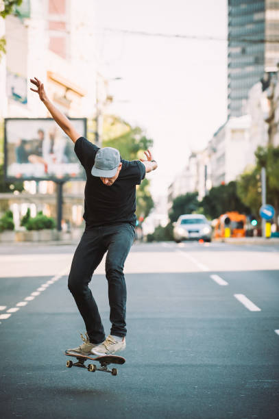 istock Pro skater doing tricks and jumps on street. Free ride 866374816