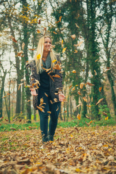 istock Young woman playing in park 866375202