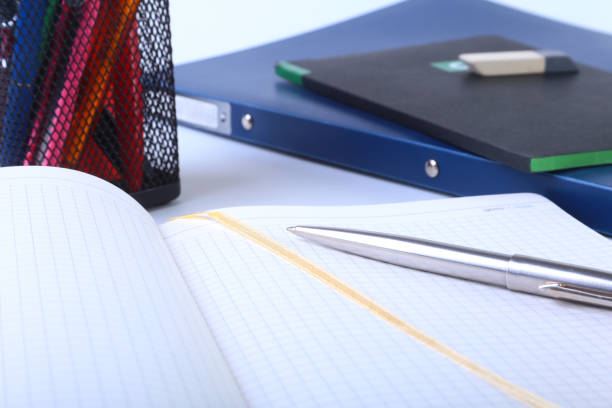 istock Colorful notebooks and office supplies on white table. 866381832