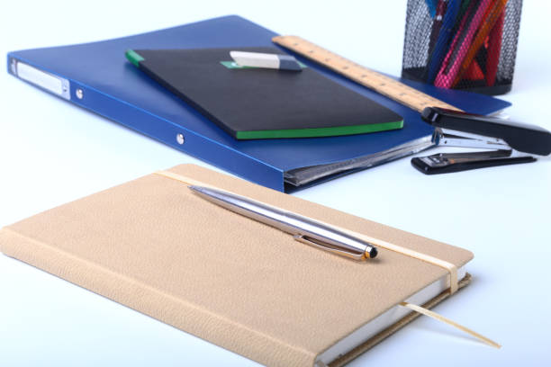 istock Colorful notebooks and office supplies on white table. 866381890