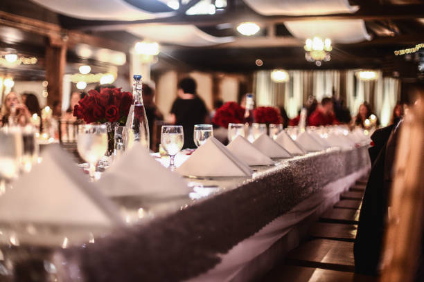 Elegant Dining Looking down the table at placesetting with wine glasses, folded formal dinning stock pictures, royalty-free photos & images