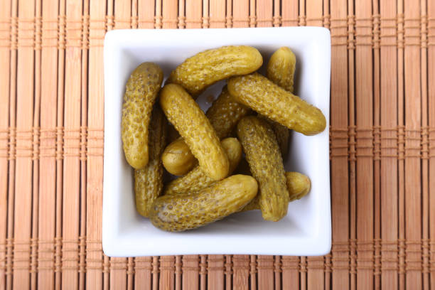 Pickles. Bowl of pickled gherkins cucumber with copy space. Cornichons