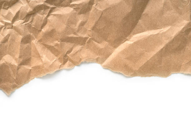 Craft paper torn edge Crumpled craft paper torn edge. On white background torn brown paper stock pictures, royalty-free photos & images