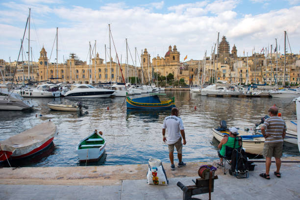Boats and yachts anchoring in Valletta, Malta VALLETTA, MALTA - AUGUST 23, 2017: Boats, ships and yachts anchoring in Birgu harbor, one of the biggest port from the Three Cities of Malta coconut crab stock pictures, royalty-free photos & images