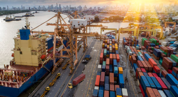 istock Logistics and transportation of Container Cargo ship and Cargo plane with working crane bridge in shipyard 866404492