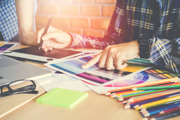 Designer graphic creative  working on Mouse pen,laptop in  office